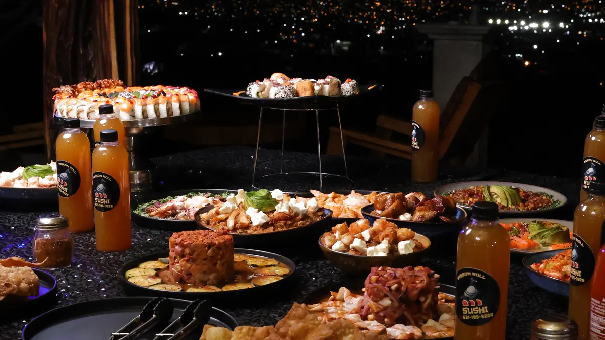 A Pigeon Roll sushi banquet at a night event, with the city lights behind it